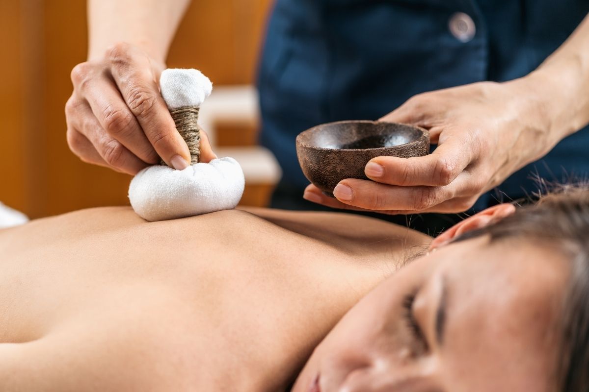 A person receiving Potli Therapy in a tranquil spa environment to relieve tension and rejuvenate the body.