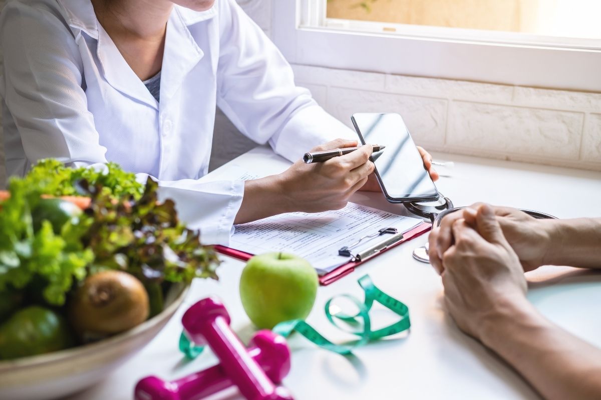 Dietitian creating a custom diet plan for a client to achieve their health goals.