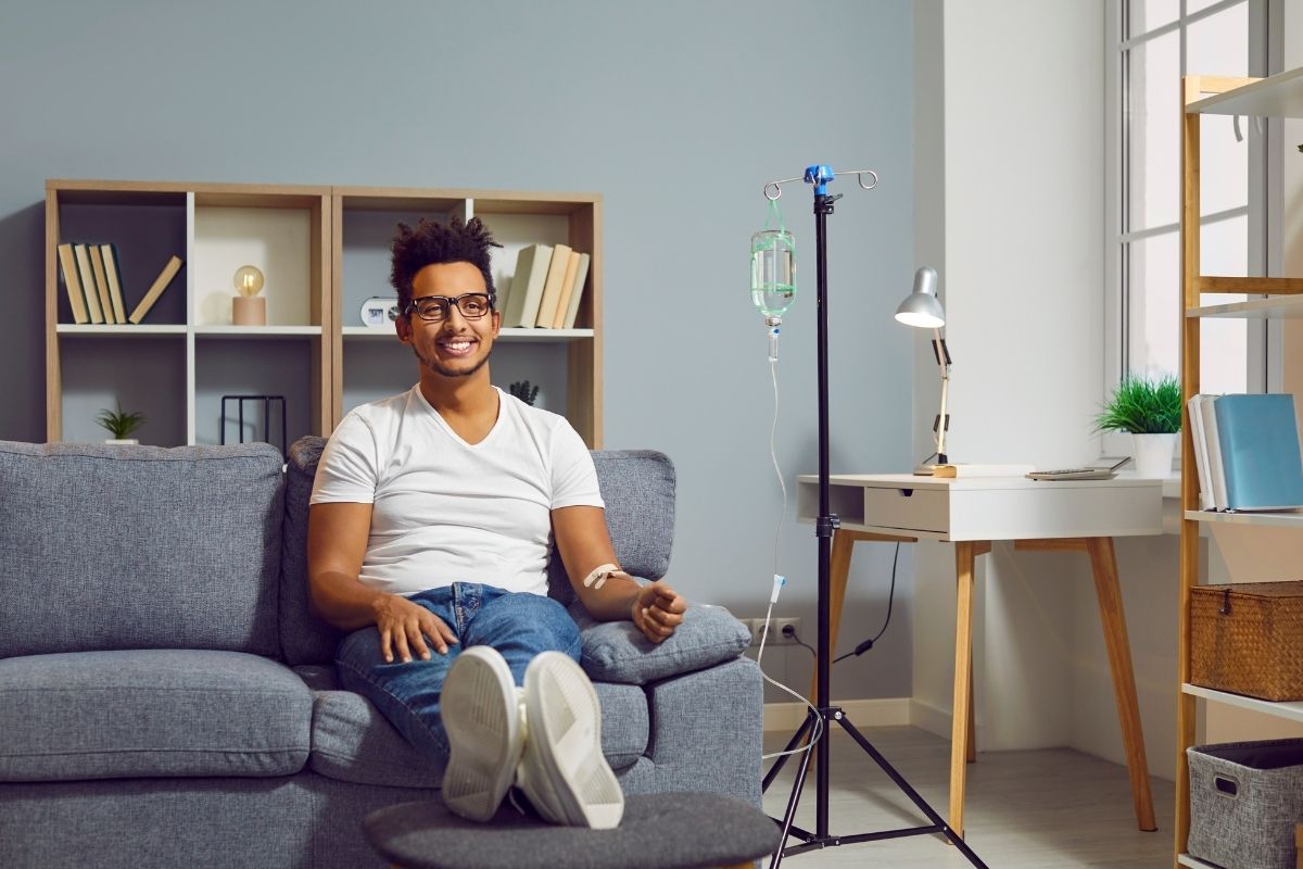 A happy client undergoing IV Drip therapy to rejuvenate their body.