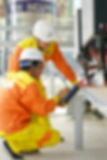 Technician performing electrical test and tag on office equipment