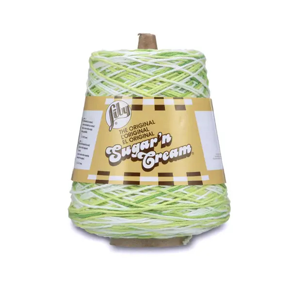 lily sugar n' cream cone yarn in the colour key lime pie ombre, a mix of white and light greens