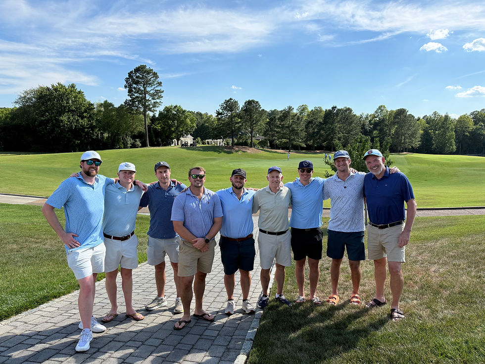 Group of people outdoors on a golf course at golden hour, relaxed and casual, mixed genders, warm natural colors, landscape orientation, focus on connection and movement rather than competition.