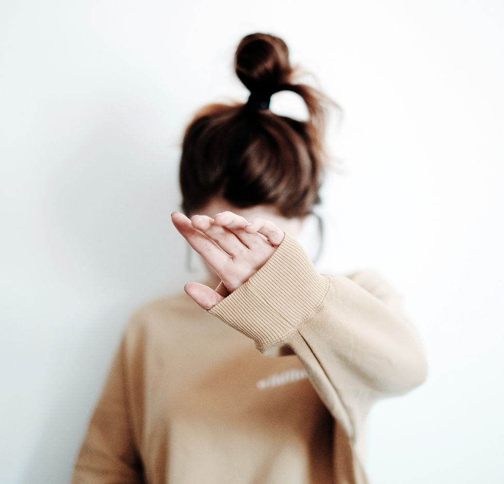 Woman hiding her face because she feels shame