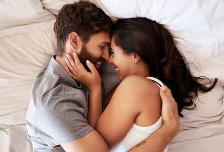 Smile, bed and happy couple hug, relax and spending lazy morning together, bonding and int