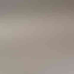 Close-up of completely dust-free white baseboards and clean walls.