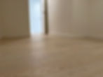 Hardwood bedroom floor in a Richmond condo after move-out floor cleaning, with dust-free baseboards.