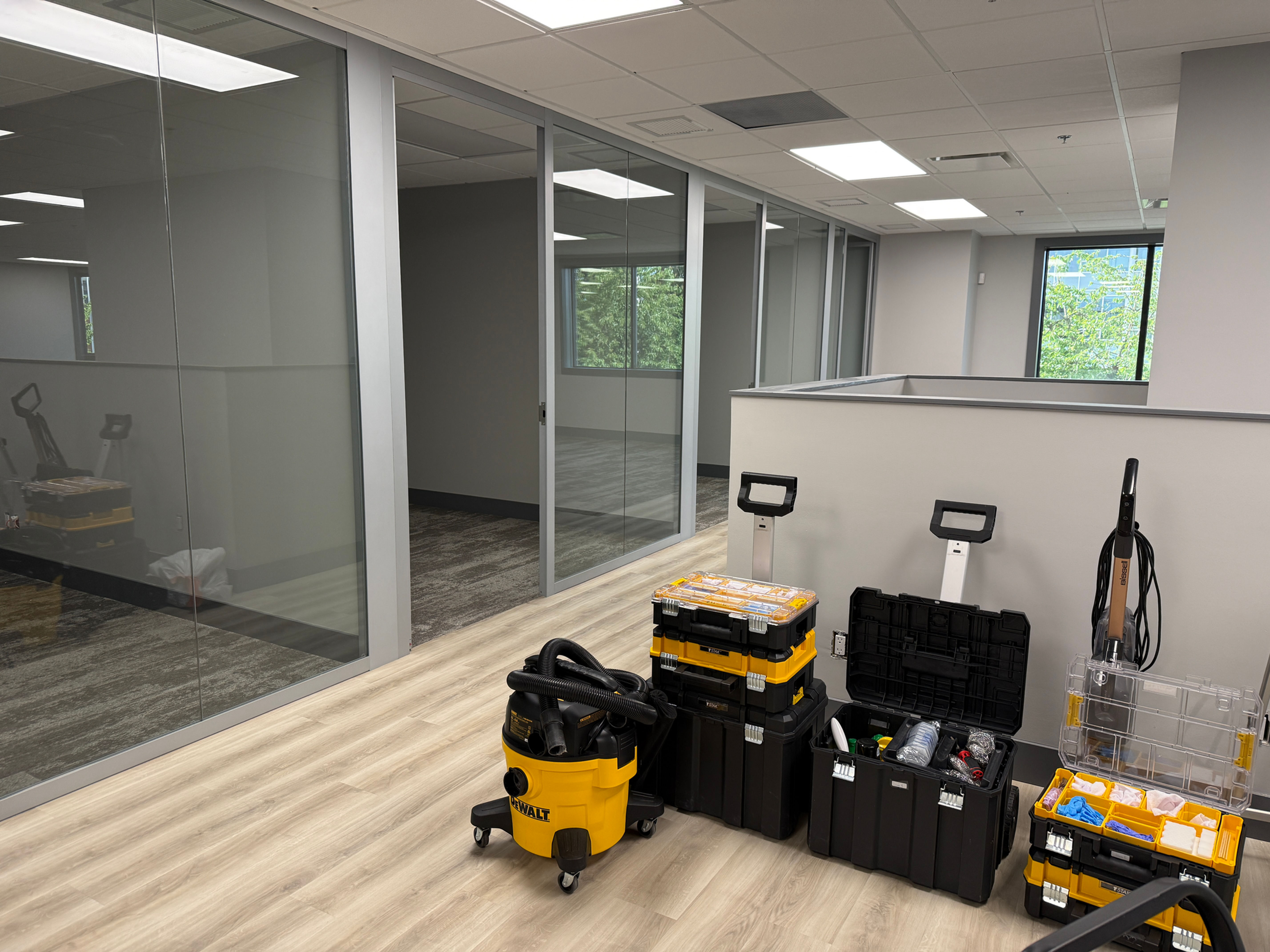 Professional cleaning equipment and HEPA vacuums inside a newly renovated modern office space, ready for commercial post construction cleaning in Metro Vancouver.