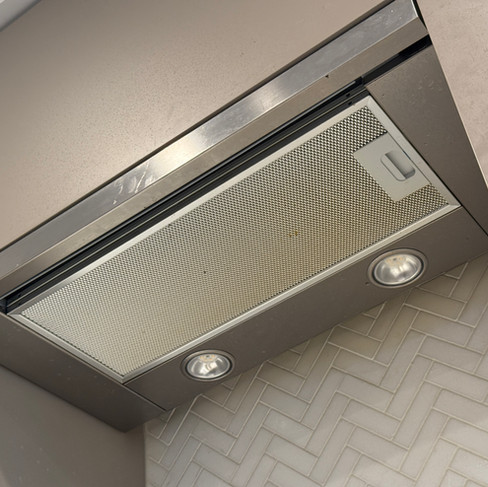 Range hood surface before kitchen move-in cleaning in a Burnaby condo