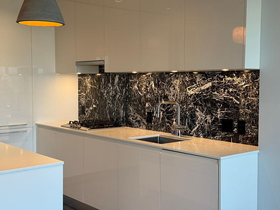 Sparkling clean modern kitchen with white cabinets and a marble backsplash after a professional move-in cleaning in Burnaby.