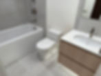 Bright modern bathroom after move-out cleaning in Metro Vancouver – clean bathtub, toilet, vanity and floor tiles.