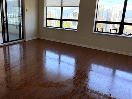 Shiny hardwood living room floor in Burnaby condo after professional move-out cleaning by OnePro Cleaning