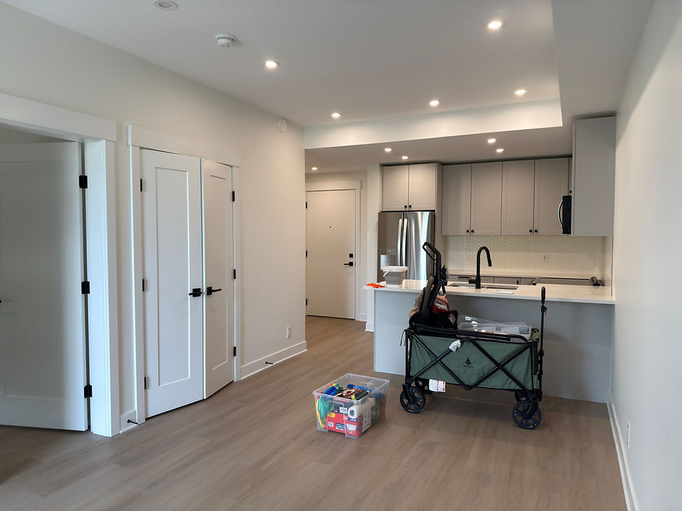 Spotless Langley condo kitchen and living area after professional move-out cleaning – floors, cabinets, and countertops shine.