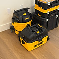 Professional DeWalt HEPA vacuums on wooden floor used for fine dust removal during post-renovation cleaning in Port Moody