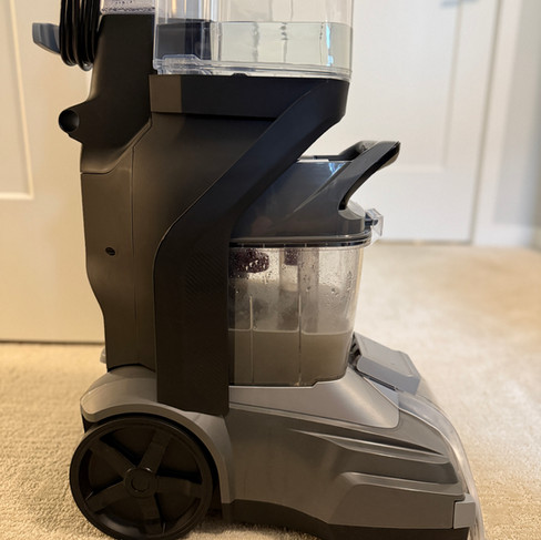 Professional carpet cleaning machine extracting dirt and water from carpet in a Coquitlam condo—carpet cleaning by OnePro Cleaning.