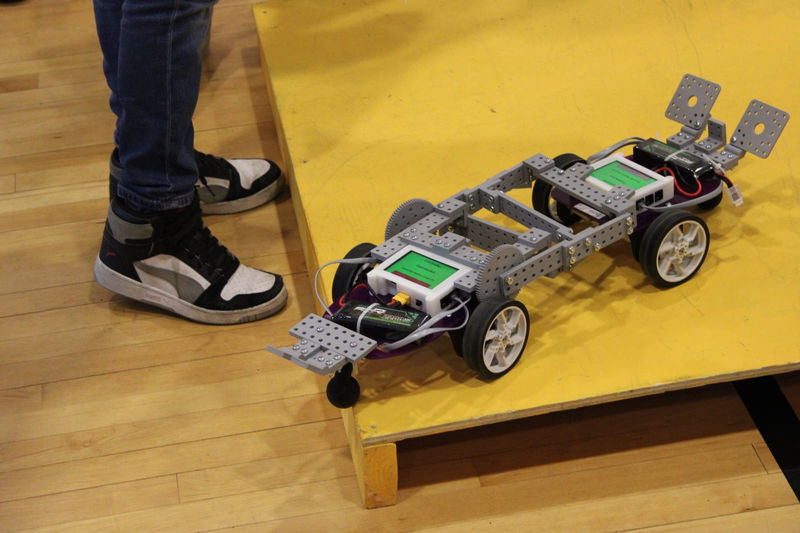 A student robot climbs onto the platform during King of the Hill.
