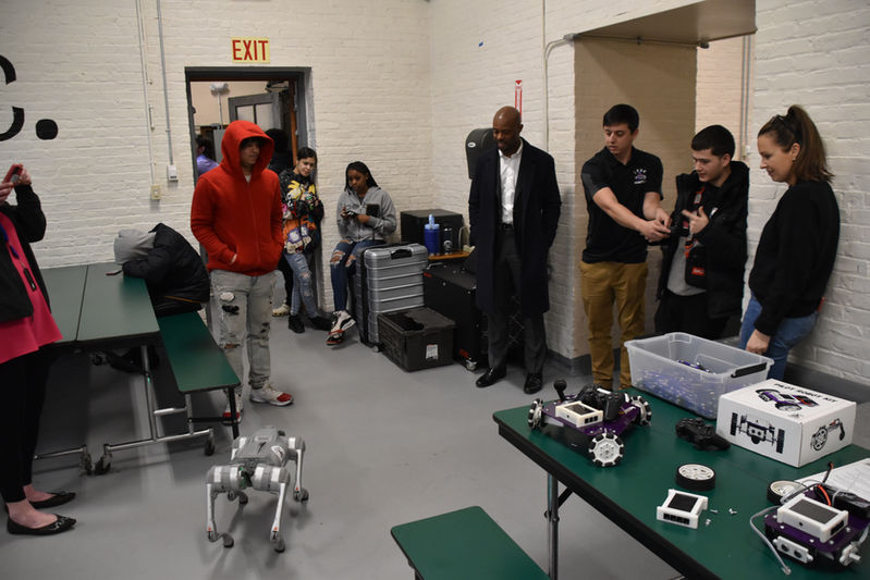 Students Playing with Robot Dog