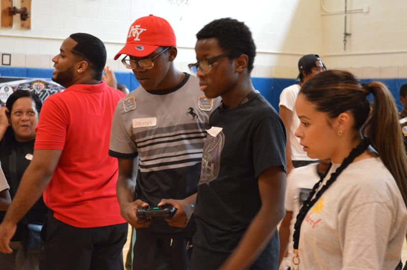 Students focus on their controllers during a match.