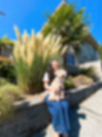 Asian female with mini schnauzer on her lap