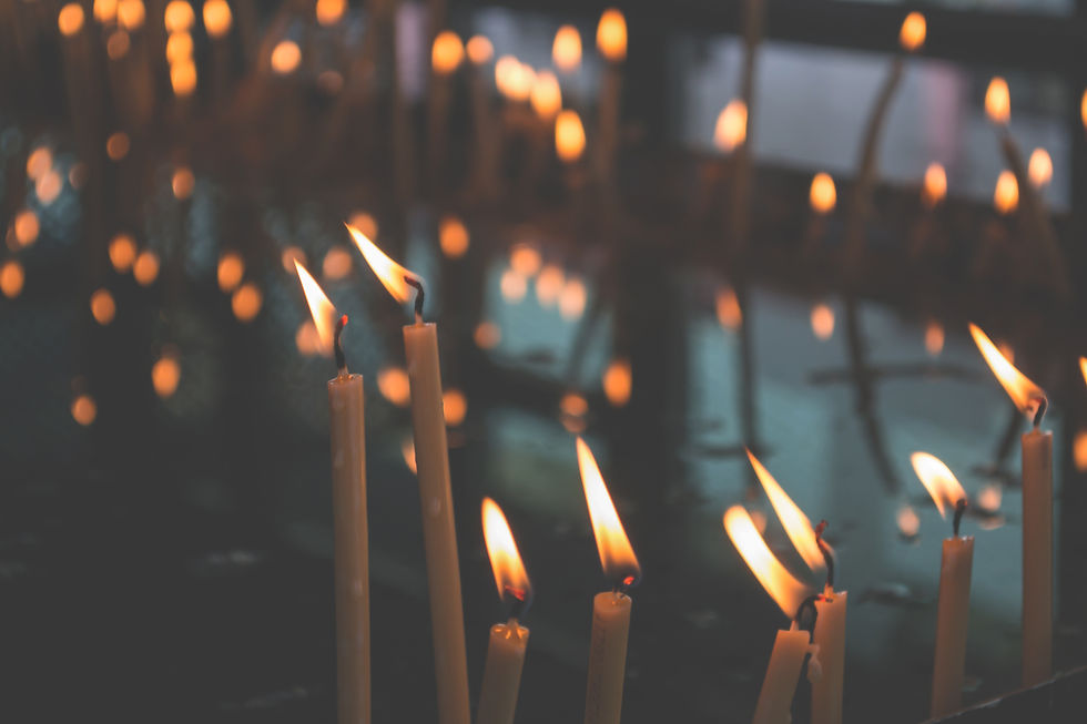 many small candles glowing in a dark room