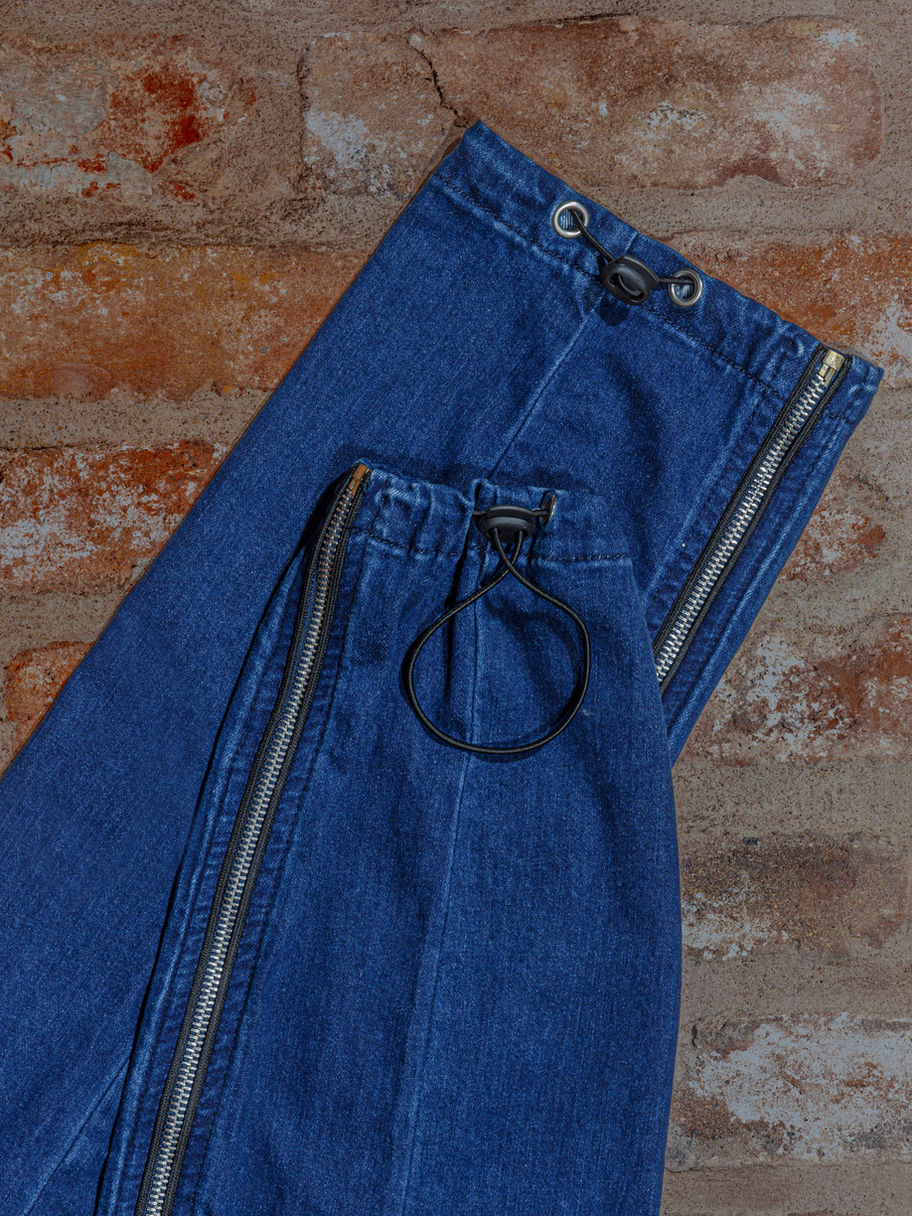 Denim adapted cargo trousers image showing drawstring cuffs on a brick background