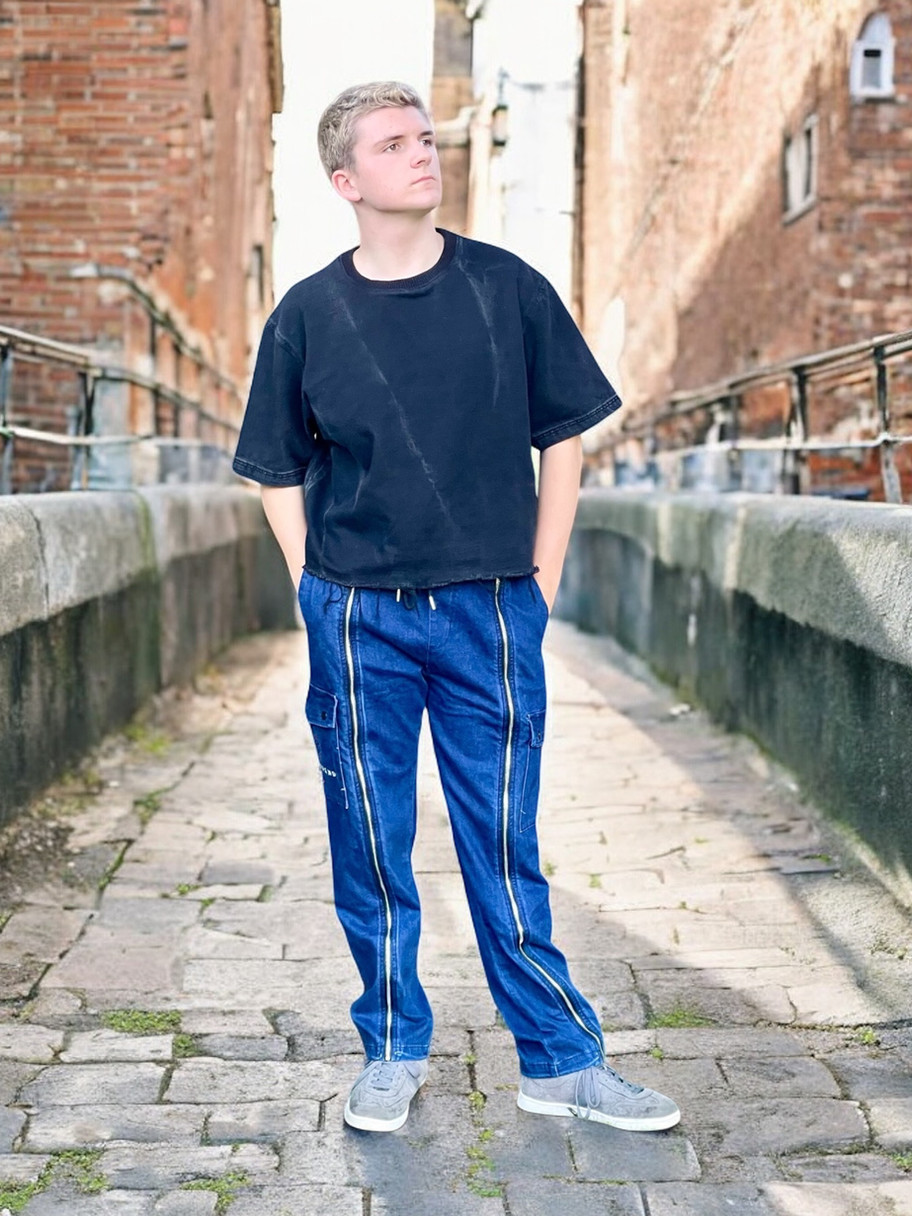 Denim adapted cargo trousers worn by Jake modelling outside in a street