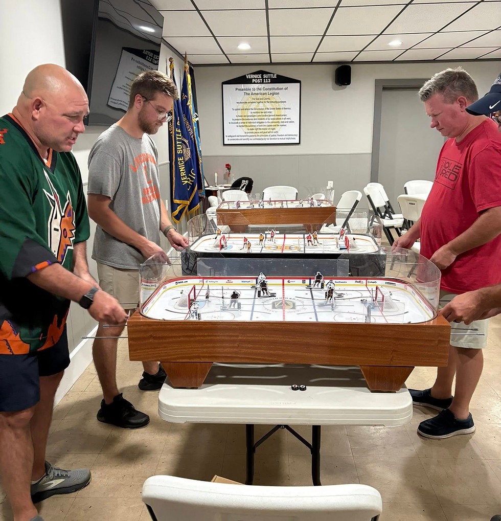 men playing table hockey