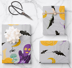 Wrapping paper with a modern whimsical Halloween design with ghosts, flowers, bats, and spiderwebs on a gray background.