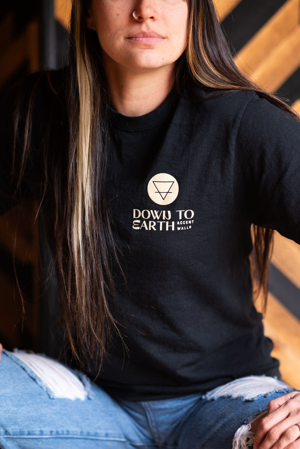 A depiction of a woman wearing a company-branded shirt for business marketing purposes.