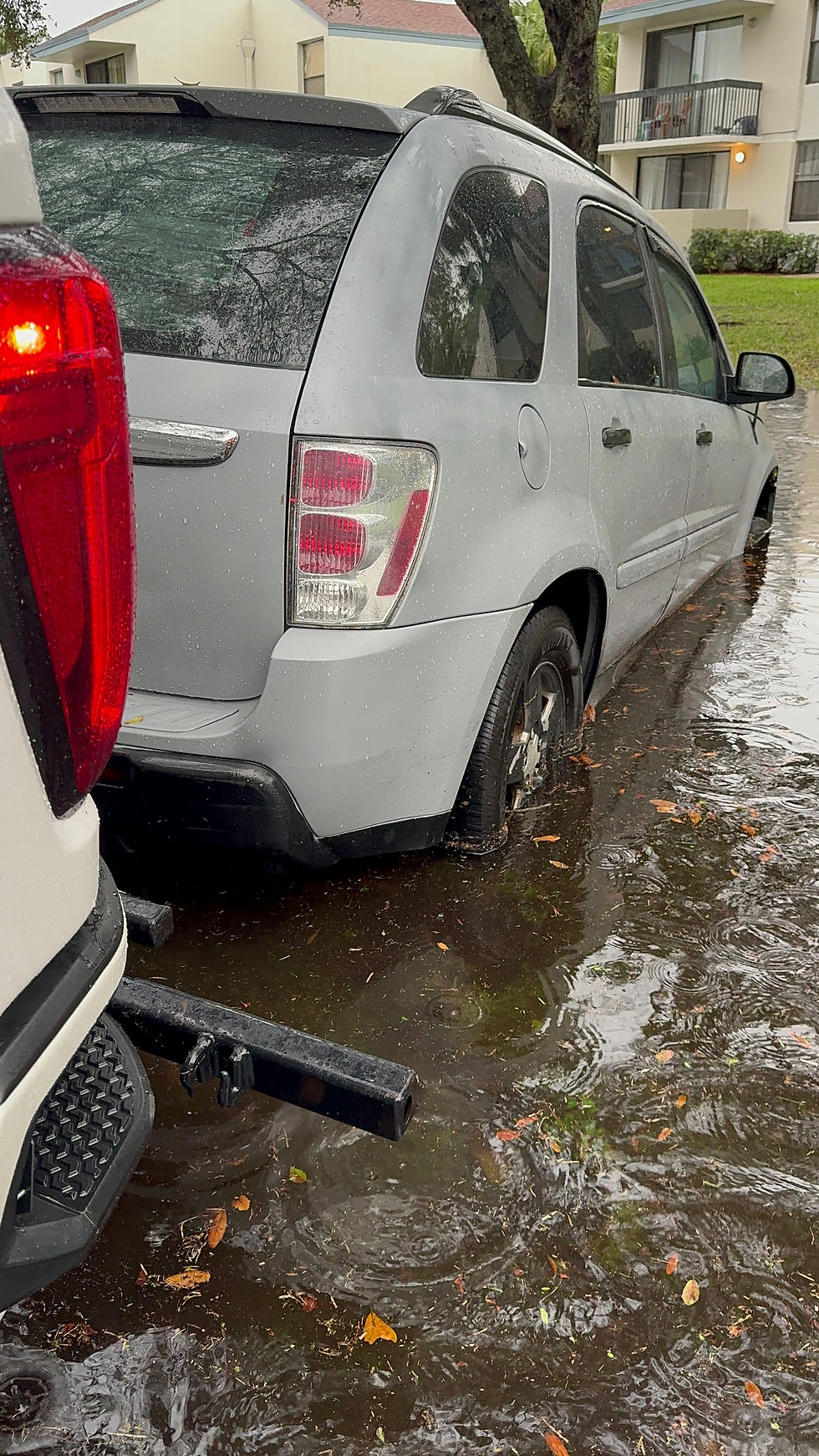 Tow truck recovering a flood-affected vehicle in Harmony, Florida