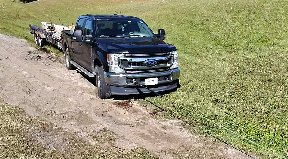 Pickup truck being recovered from an off-road grassy area