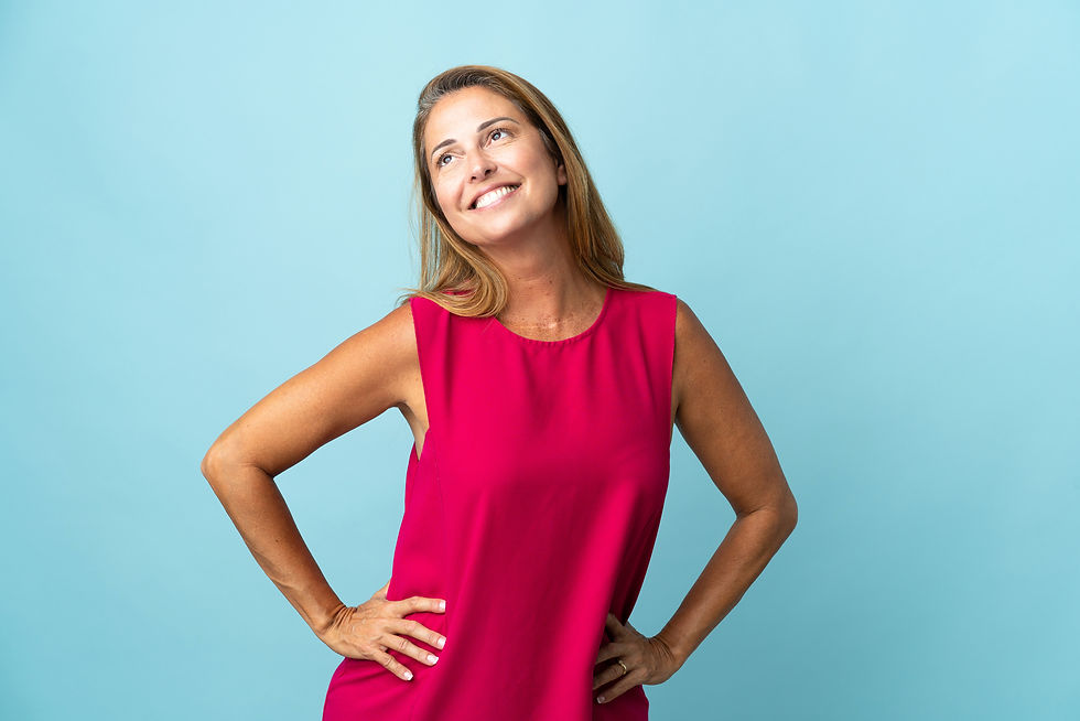 Confident young woman smiling wearing top with light blue background