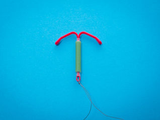 An intrauterine device on a blue background