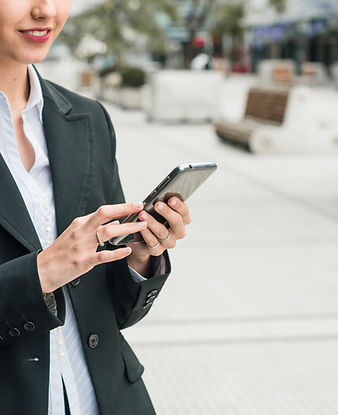 smiling-young-businesswoman-using-smart-phone.jpg