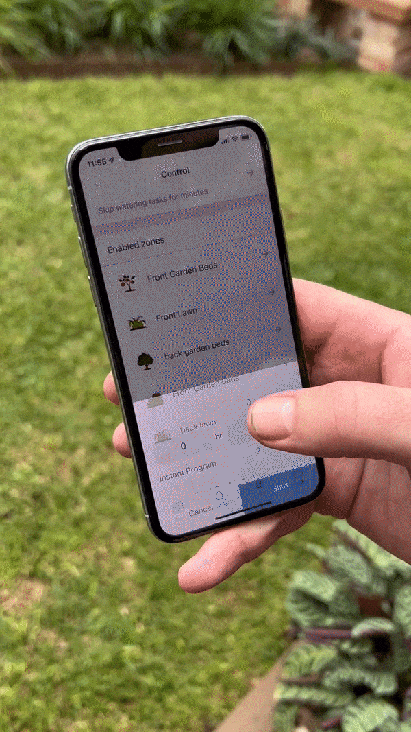 Video of someone using their phone to set the timer for their garden irrigation system