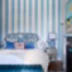 Blue and white vertical stripe wallpaper installation in boutique guesthouse bedroom, Cape Town — Atlantic Walls