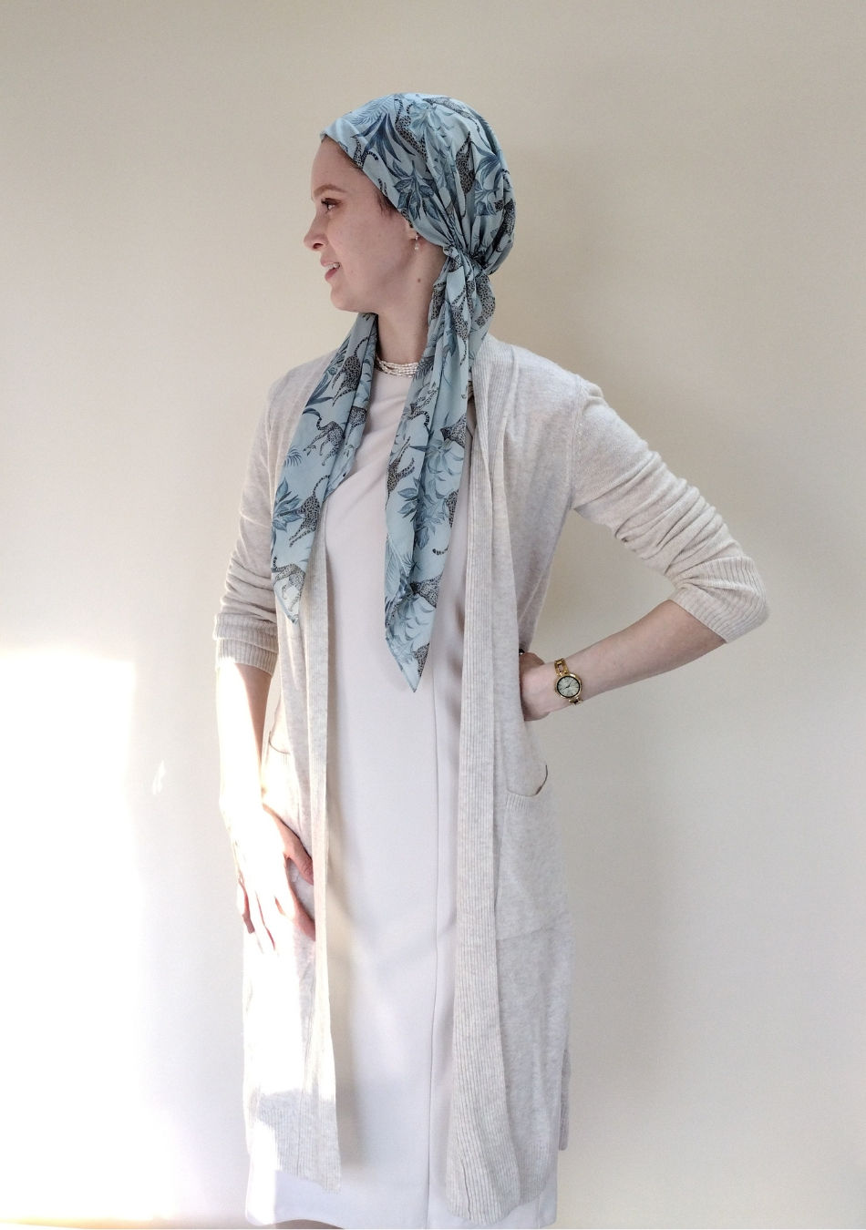 A pre tied head scarf with an ivory modest outfit.