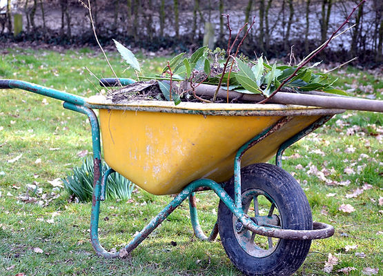 A wheelbarrow filled with garden waste—SmartClear can help take care of the cleanup once your gardening is done.