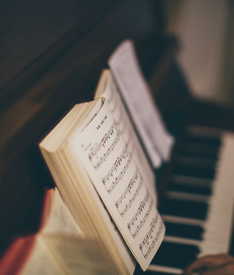 Sheet Music Over Piano