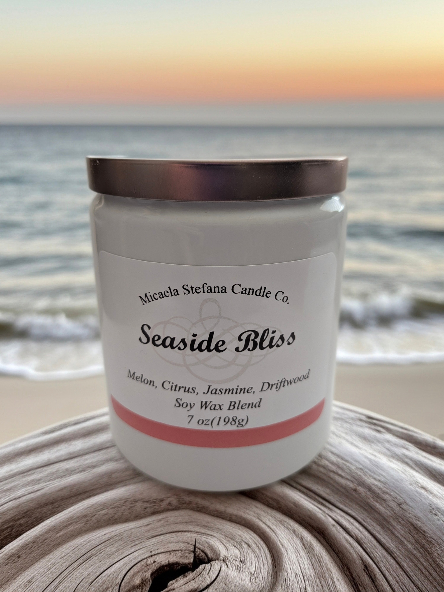 Seaside Bliss 7oz. candle in a white ceramic jar with a rose gold flat lid.