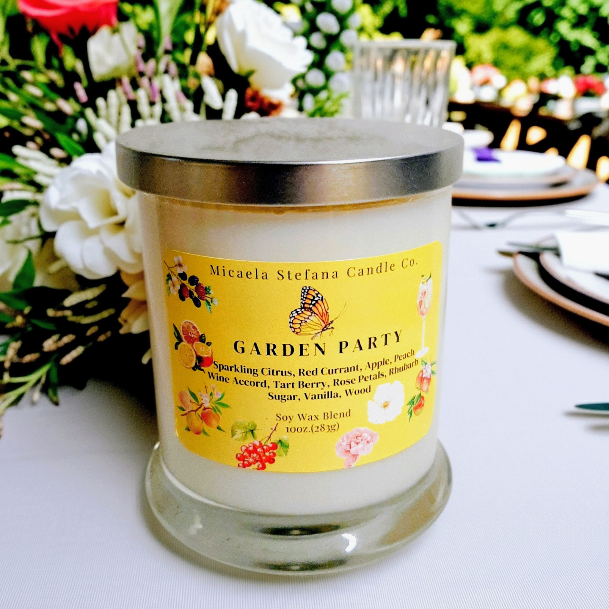 10oz. Garden Party Candlein a clear jar with a silver lid.