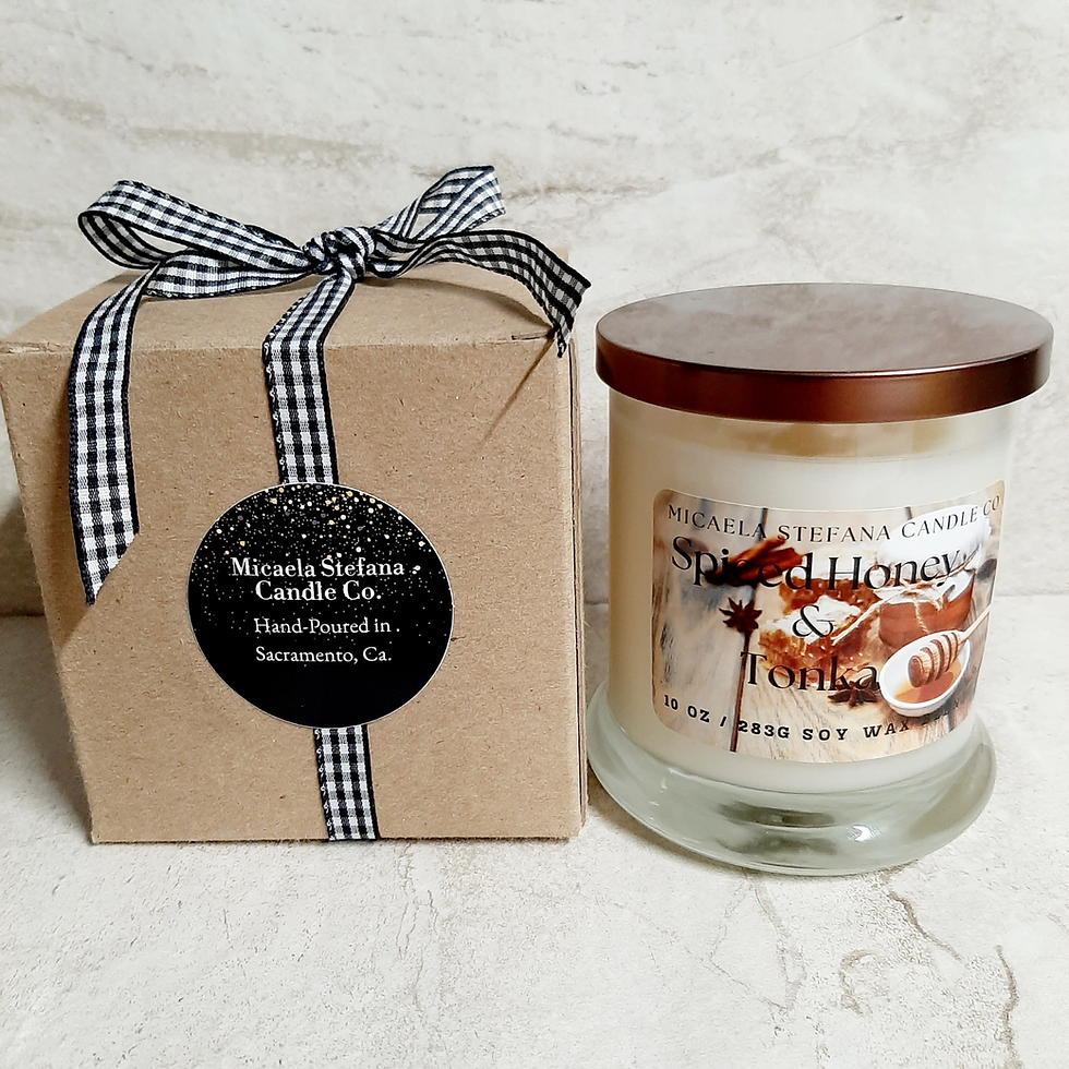 Thumbnail: Spiced Honey& Tonka candle beside a kraft gift box with a gingham ribbon and brand label.
