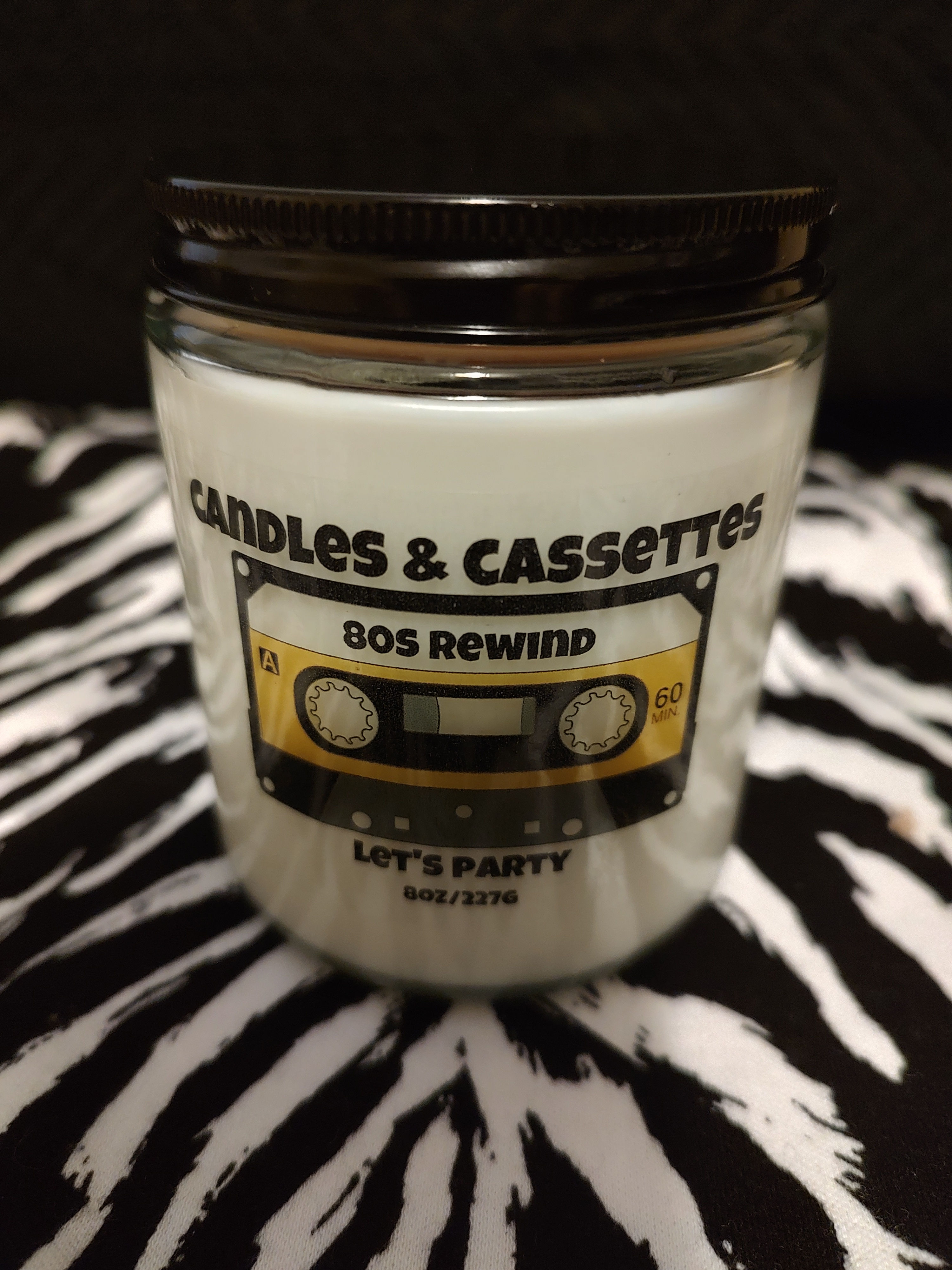 8oz. Let's Party 80s inspired candle is a pineapple, peach and grapefruit scented.