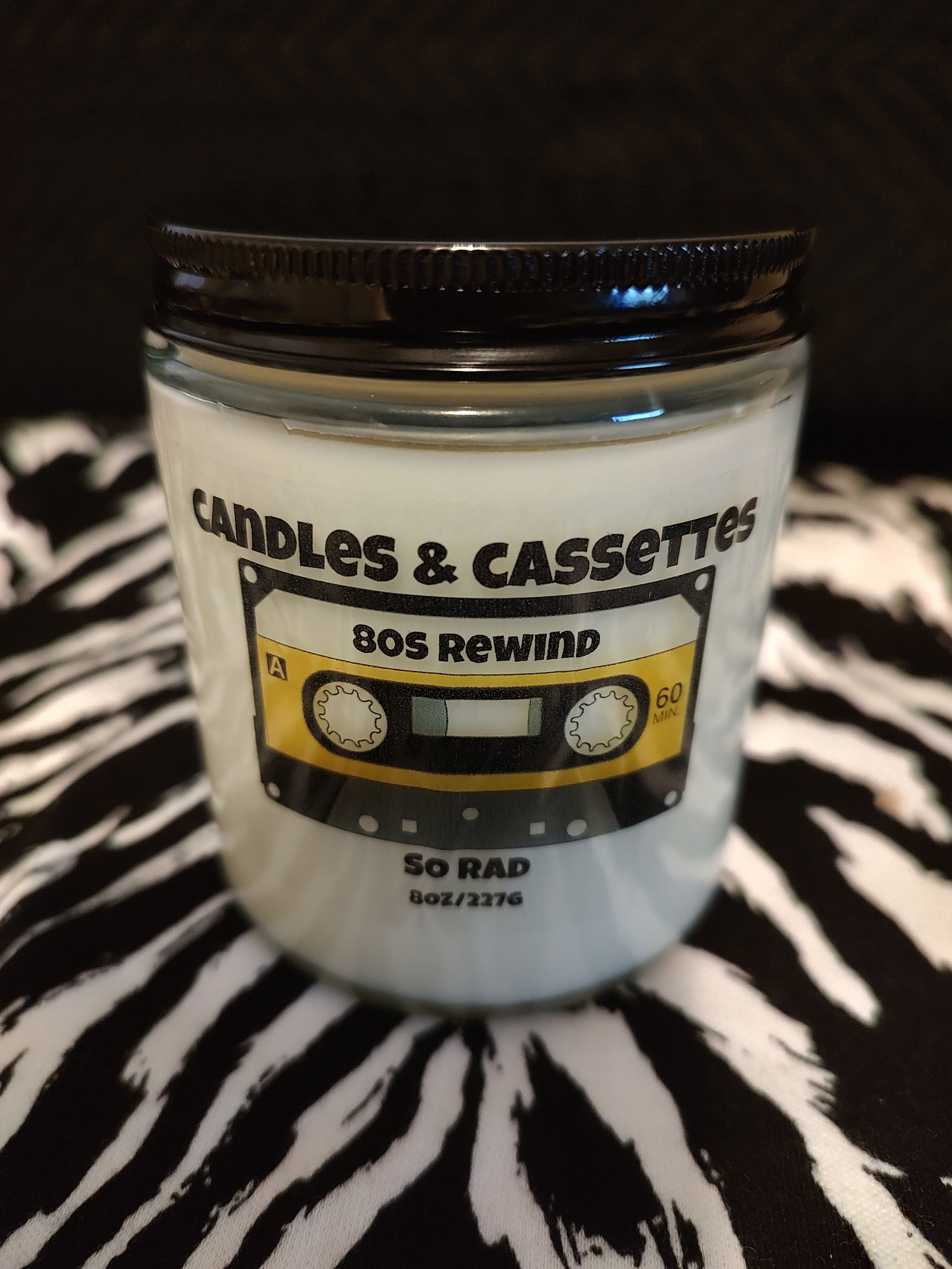 8oz. So Rad candle 80s inspired . It has notes of Lemon, Orange, and Fresh Ozone, and Briny Sea Salt.
