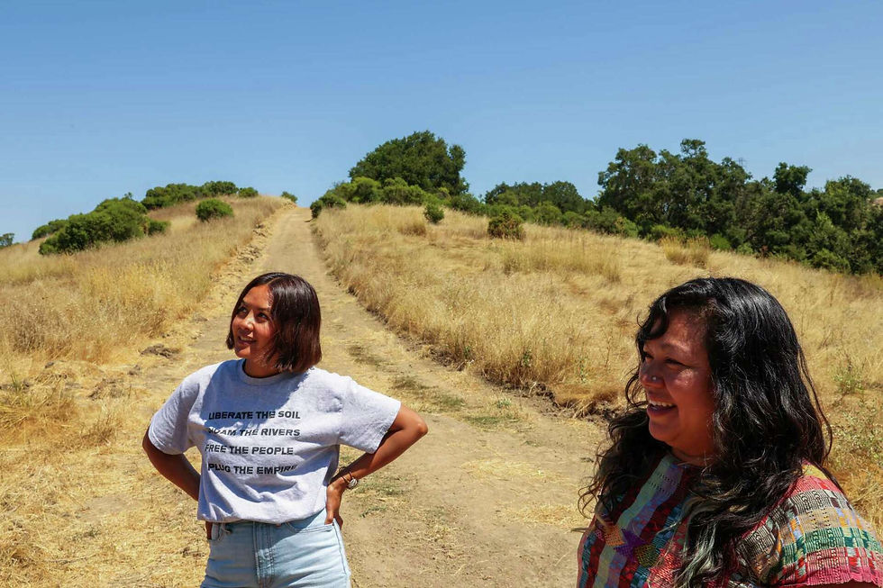 Two women on a grassy hill