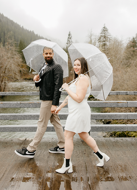 Couple holding hands walking in the rain