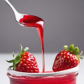 strawberry syrup running from a spoon with white background.jpg