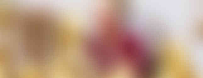 smiling woman seated at table with gourd