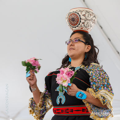 Zuni woman performing with a pot carried on her head