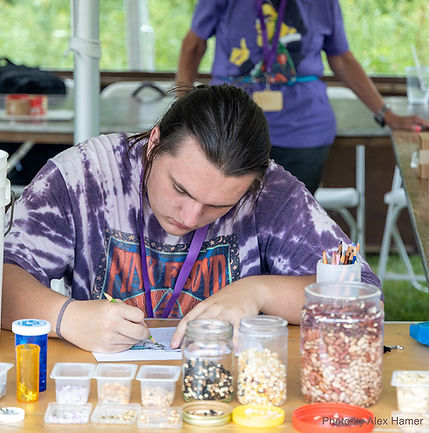 A young many coloring in a picture