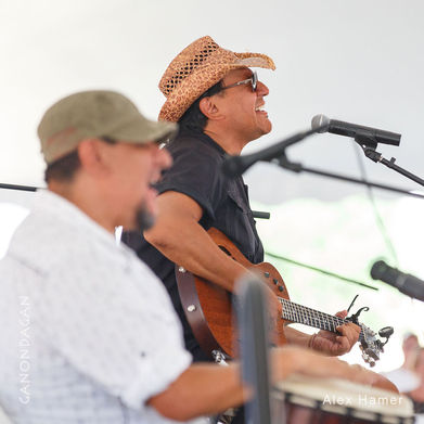 Tonemah singing and playing guitar with another man